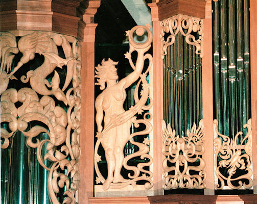 Life-sized sculpture of woman with orb, pipe shade carvings at Fritts pipe organs, Pacific Lutheran University